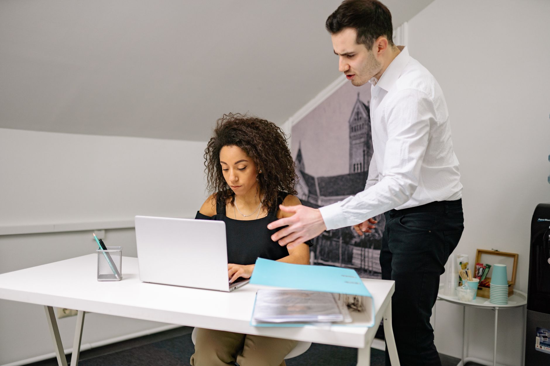 Manager and employee in discussion at the office, highlighting workplace dynamics.